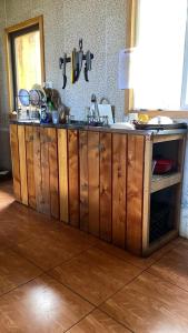 a kitchen with a sink and a counter top at Surí refugios Villa O'Higgins, Fin de la Carretera Austral in Villa O'Higgins