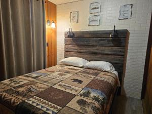 a bedroom with a bed with a quilt on it at Bayview Campgrounds in Hillsboro