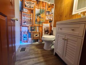 a bathroom with a toilet and a wall of pictures at Bayview Campgrounds in Hillsboro +50 photos
