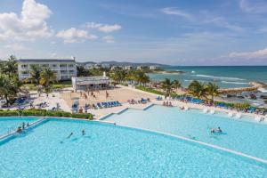 an overhead view of a large swimming pool next to the beach at Grand Palladium Jamaica Resort & Spa All Inclusive in Lucea
