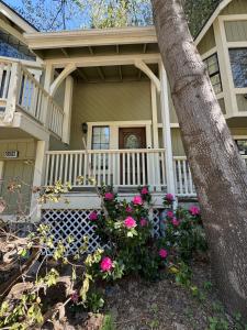 ein Haus mit rosa Blumen davor in der Unterkunft Woodsy Chic Family-Friendly Spacious Getaway in Lake Arrowhead + 39 Fotos