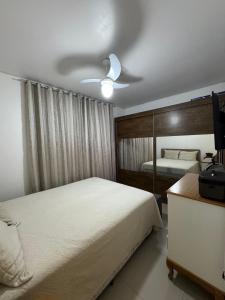 En eller flere senge i et værelse på Apartamento Familiar Para Suas Férias