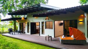 a house with a wooden deck in the yard at Villa Alma Verde in Fortuna