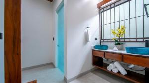 a bathroom with a blue sink and a mirror at Villa Alma Verde in Fortuna +86 photos