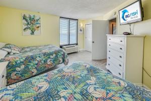 a hotel room with two beds and a tv at Pets welcome,direct oceanfront, poolside,1 bedroom in Myrtle Beach +43 photos