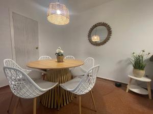 a dining room with a table and chairs and a mirror at Laurencia in Fuente Obejuna
