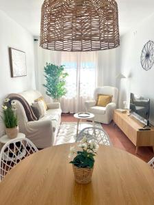 a living room with a large chandelier above a table at Laurencia in Fuente Obejuna