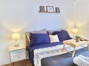 a bedroom with a blue bed with two lamps and a table at Nuevo Exclusivo con vista panoramica al mar - Ocean View in Lima