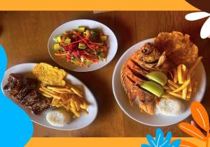 três pratos de comida numa mesa de madeira em Hotel Takuara em Vergara