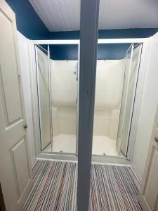 a walk in shower with glass doors in a room at Number 75 in Brighton & Hove