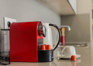 a red and white toaster sitting on top of a counter at M Résidence Marrakech Luxury Serviced Apartments in Marrakesh