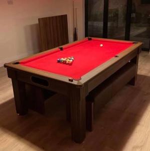 a pool table with a red cloth on it at Stylish 2BD, Near O2, WIF, Sleeps 6, London in London