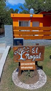 a wooden sign in front of a house at El Nogal in Sierra de la Ventana