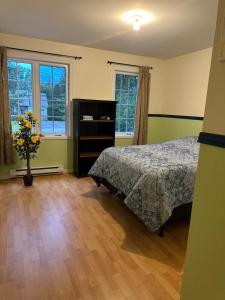 Ένα ή περισσότερα κρεβάτια σε δωμάτιο στο Havre du lac magog