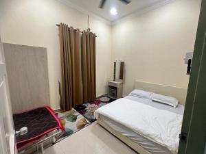 Postel nebo postele na pokoji v ubytování Tengku Resident