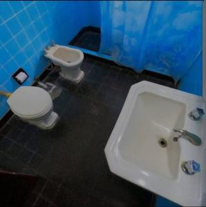 ein Badezimmer mit einem weißen Waschbecken und einer Toilette in der Unterkunft Casa en Alquiler San Bernardo in San Bernardo