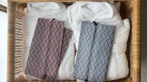 two towels in a basket with towels at TSUKI Tokyo in Tokyo