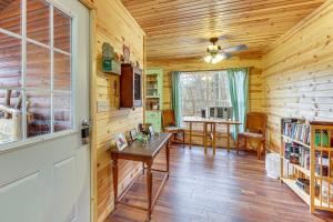 a wooden room with a table and a dining room at Greenbrier River On-Site! Modern-Rustic Log Cabin in Marlinton +18 photos