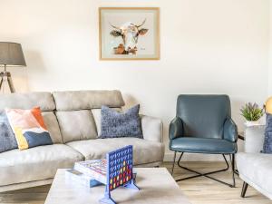 a living room with a couch and a cow on the wall at Cefn Gelli in Clynderwen +38 photos