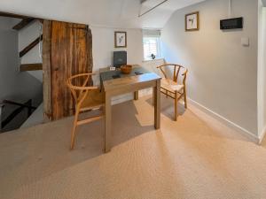 a dining room with a table and two chairs at The Merchants Penthouse - Uk50408 in Canterbury