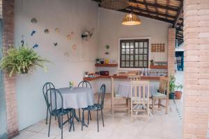 a dining room with two tables and chairs at Pousada do Mestre in Pontal do Paraná