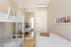 a small room with two bunk beds and a mirror at Refúgio VIP Pé na Areia no Campeche - Piscina, Sauna e Academia até 08 pessoas in Florianópolis +71 photos