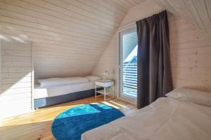 a small room with two beds and a window at Xanadu Resort in Sianozety