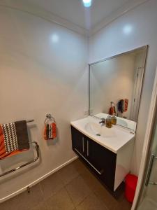 a bathroom with a sink and a mirror at Enjoy 4br home with lots of comfort & convenience in Taupo +28 photos