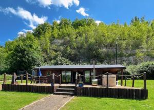 a small cabin with a playground in a field at St Andrews Lakes in Halling +34 photos