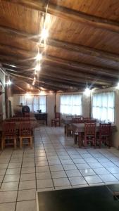 ein großer Raum mit Tischen und Stühlen und Fenstern in der Unterkunft Hostería de Montaña Las Pataguas in El Hoyo + 70 Fotos