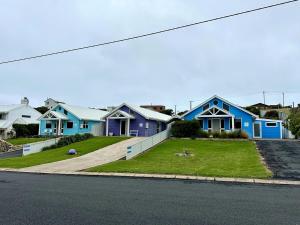 a row of blue houses on a street at Dunes Aqua at Robe in Robe