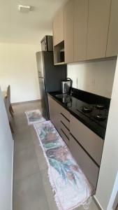 a kitchen with a stove and a counter top at Ap sol nascente in Itapema
