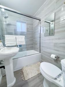 a bathroom with a sink and a toilet and a tub at Long stay Google BBQ BIG yard in Mountain View