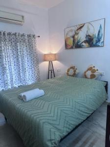 um quarto com uma cama com um edredom verde em Southside stay em Trivandrum