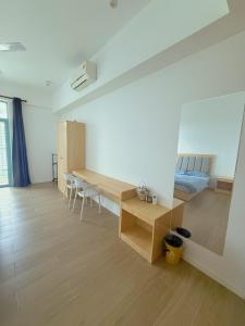 a room with a desk and a bed and a table at Bay Suites Home By Sea 海的家 1016 in Kota Kinabalu