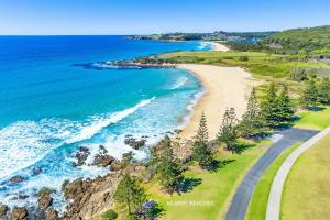an aerial view of a beach next to the ocean at Kianga Lodge, 1 Sunset Blvd in Kianga