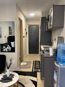 a small kitchen with a door leading into a room at Winnie's home in Athi River +5 photos