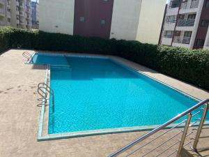 a blue swimming pool in the middle of a building at Winnie's home in Athi River