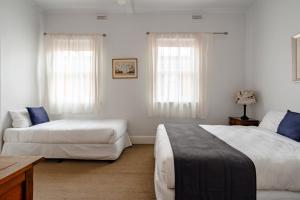 a bedroom with two beds and a couch at Seaview House in Queenscliff +69 photos