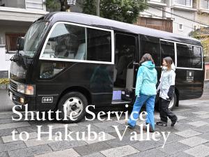 two girls walking into a shuttle service van at Matsumoto Jujo in Matsumoto