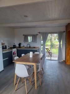 a kitchen and dining room with a wooden table and chairs at LA ARBOLADA in Mar del Plata