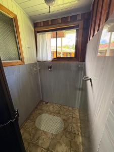 a small bathroom with a shower with a window at Campo Azul #2 - Monteverde in Monteverde Costa Rica