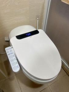 a white toilet with a remote control on it at Matsu Star Yang Homestay in Beigan +43 photos