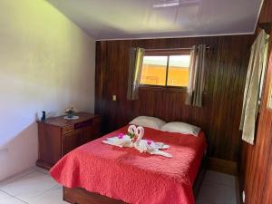 a bedroom with a bed with two swans on it at Campo Azul #2 - Monteverde in Monteverde Costa Rica