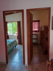 a bedroom with a bed and a door to a room at Departamento Rosales Nro 2 in Valeria del Mar