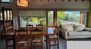a living room with a table and a couch at Casa Maloneli in Ostende +4 photos