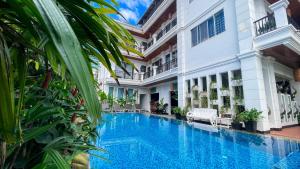 a swimming pool in front of a building at The Center Point in Siem Reap