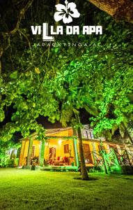 a building with a tree in front of it at Villa da Apa in Japaratinga