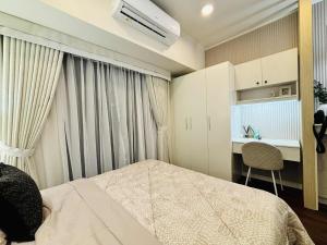 a bedroom with a bed and a desk in it at Condo Hotel Walking Abreeza Mall and Near SM Lanang in Davao City