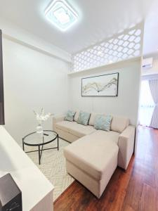a living room with a couch and a table at Condo Hotel Walking Abreeza Mall and Near SM Lanang in Davao City +2 photos